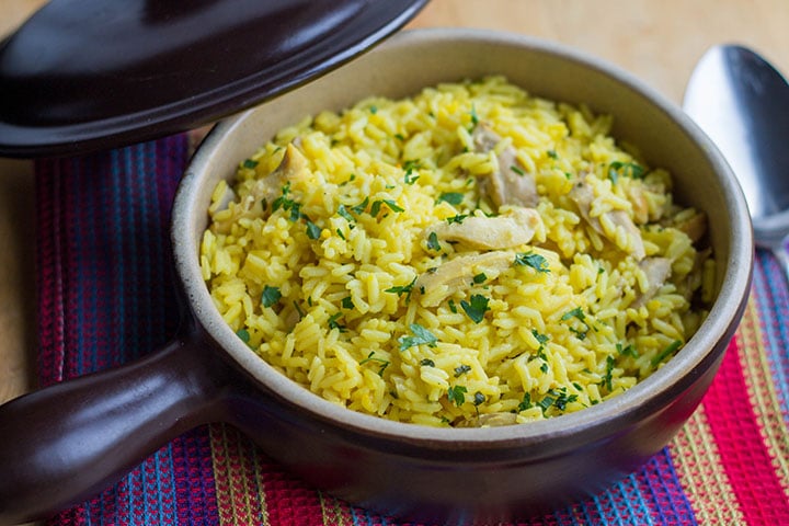 Easy One Pot Chicken and Saffron Rice in a serving dish, sprinkled with chopped parsley