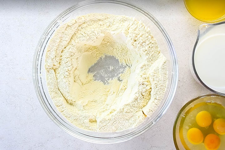 The dry ingredients in a large bowl with a well in the middle