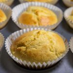 Freshly baked, golden corn muffins fresh out of the oven