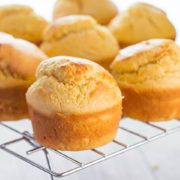 Freshly baked corn muffins cooling on a cooling rack