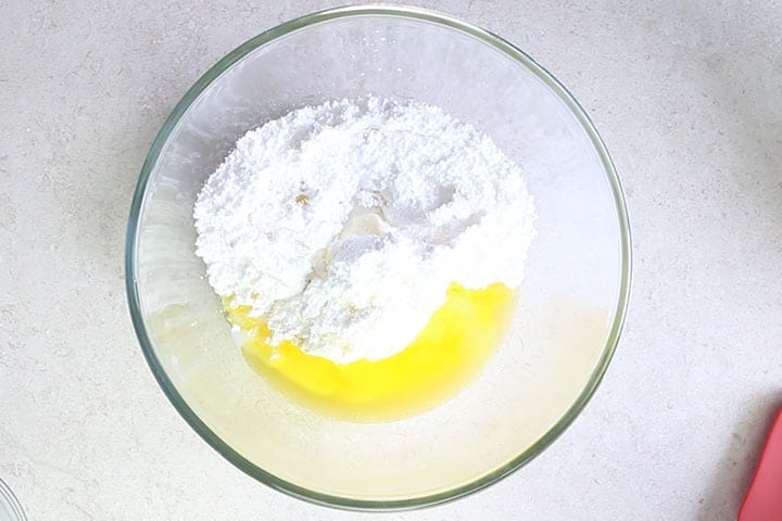 The sugar, vanilla and milk added to the bowl with the butter and cream cheese