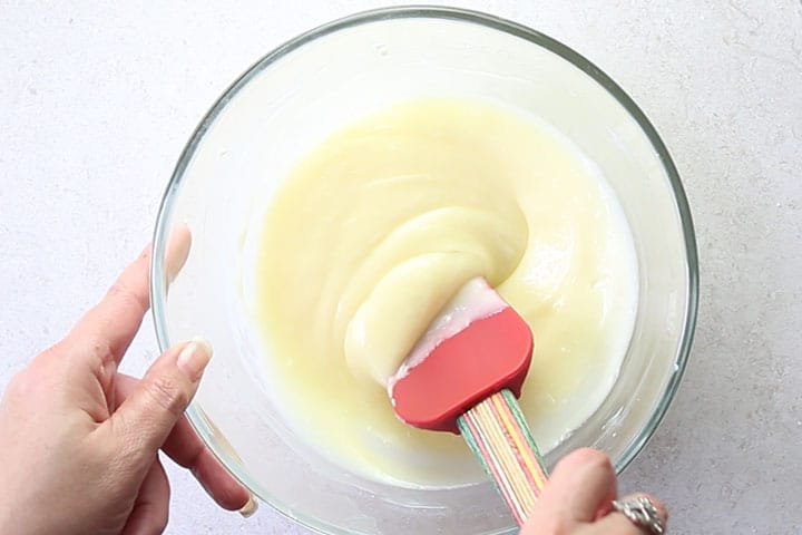 The smooth icing in a glass bowl