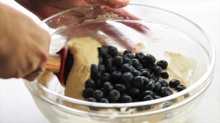 The blueberries being folded into the batter