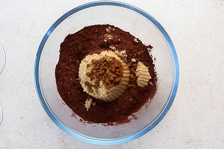 a glass bowl with cocoa powder, instant coffee and brown sugar