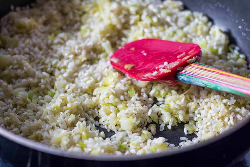 the rice added to the pan with the onion mixture