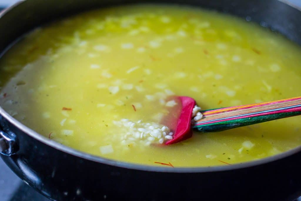 the stock added to the pan with the rice mixture