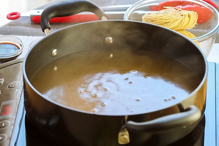 A pot of boiling chicken stock