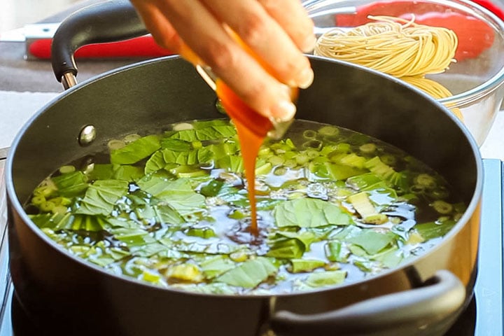 The soup with the oyster sauce added to the stock in the pan