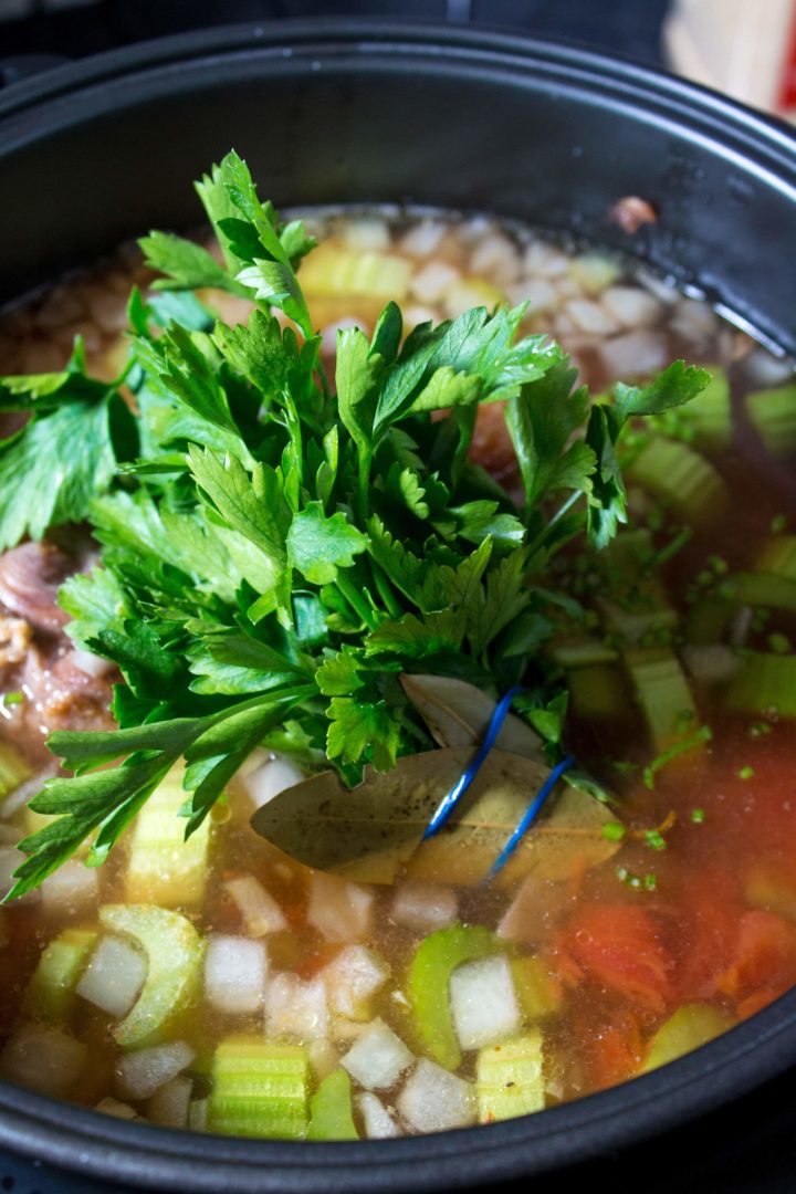 the herb bundle added to added to the slow cooker with the vegetables and oxtail, stock