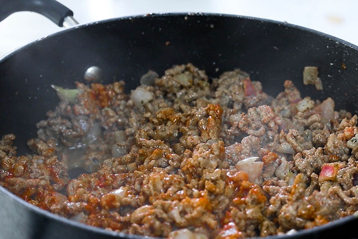 The tomato paste mixed into the meat