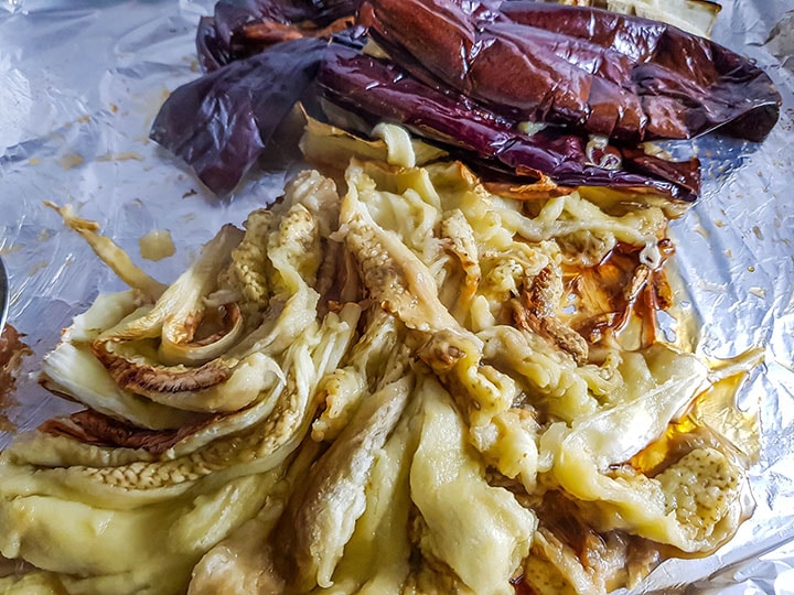 the eggplant flesh piled tohether with the skins in the background.