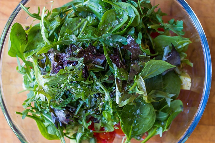 salt and fresh pepper added to the salad