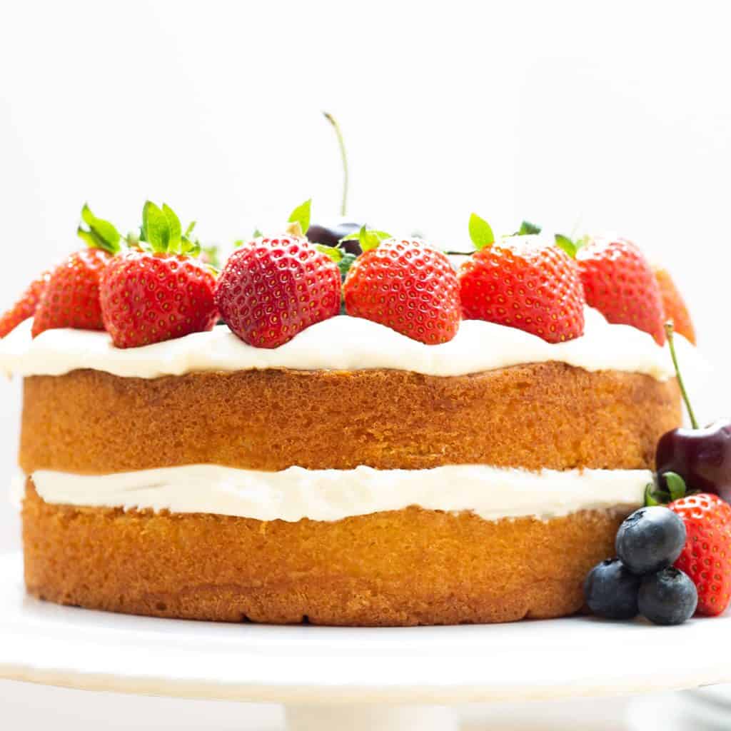 a layer cake topped with fruit