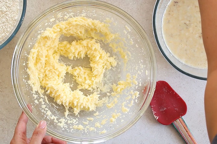 A glass mixing bowl with the butter and sugar creamed together