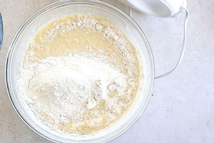 The dry ingredients added to the bowl with the wet ingredients 