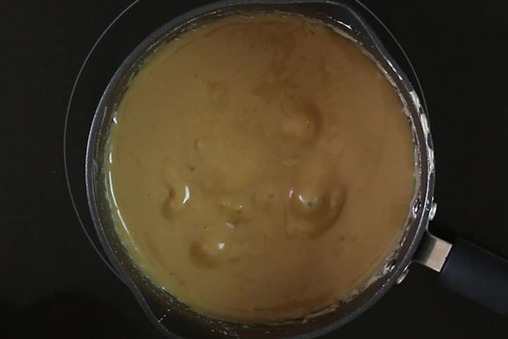 The caramel boiling in the pot