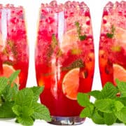 three Raspberry Mojitos with ice, lemon, lime and mint
