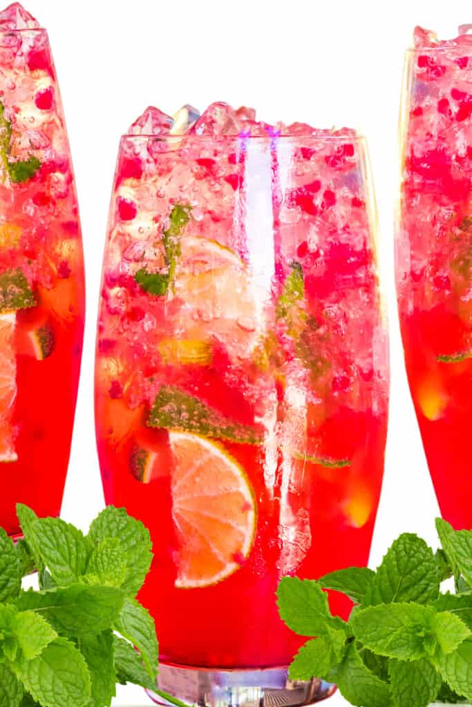 three Raspberry Mojitos with ice, lemon, lime and mint