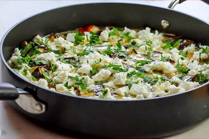 The parsley sprinkled over the feta, egg and vegetable mixture