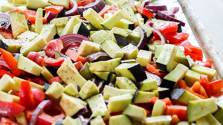 The vegetables in a single layer on a baking sheet