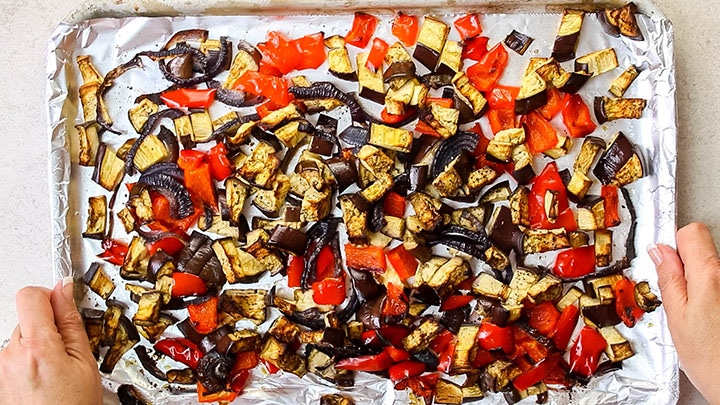 The roasted vegetables on the baking sheet fresh from the oven