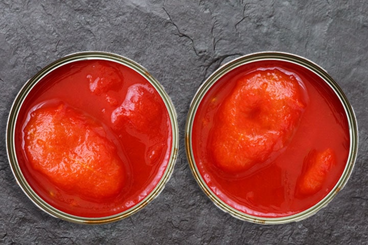 two open cans of whole tomatoes from above