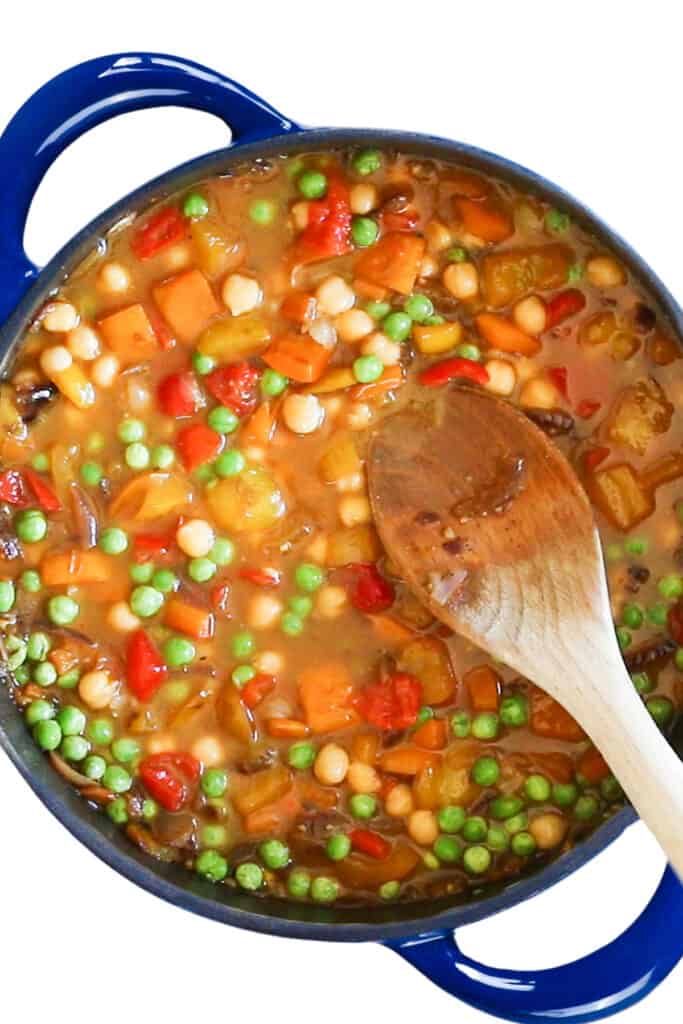 the stock mixed into the dish in the pan