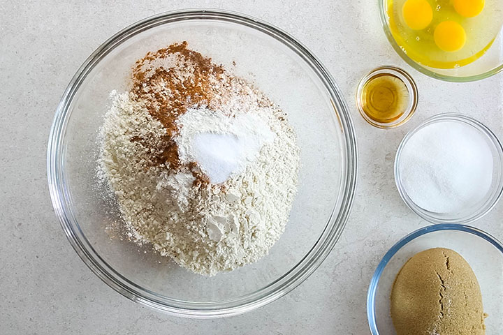 Flour, cinnamon, nutmeg, baking powder, salt, and baking soda In a large mixing bowl