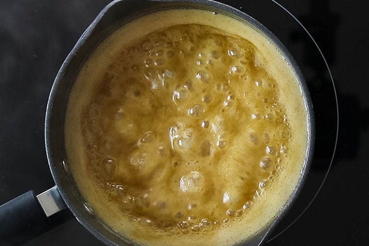The caramel glaze boiling in the pot