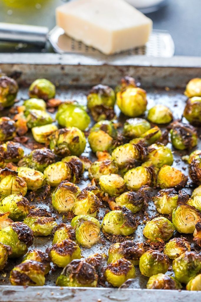 A pan with roasted Brussels Sprouts that have crisp, golden edges