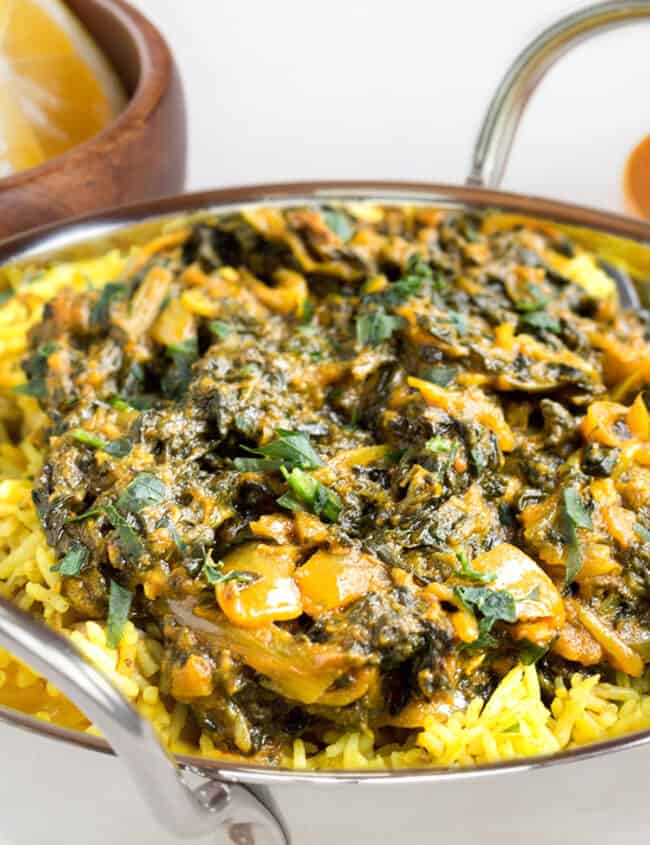 Sag Bahji {Spinach Curry} served over rice in bowl