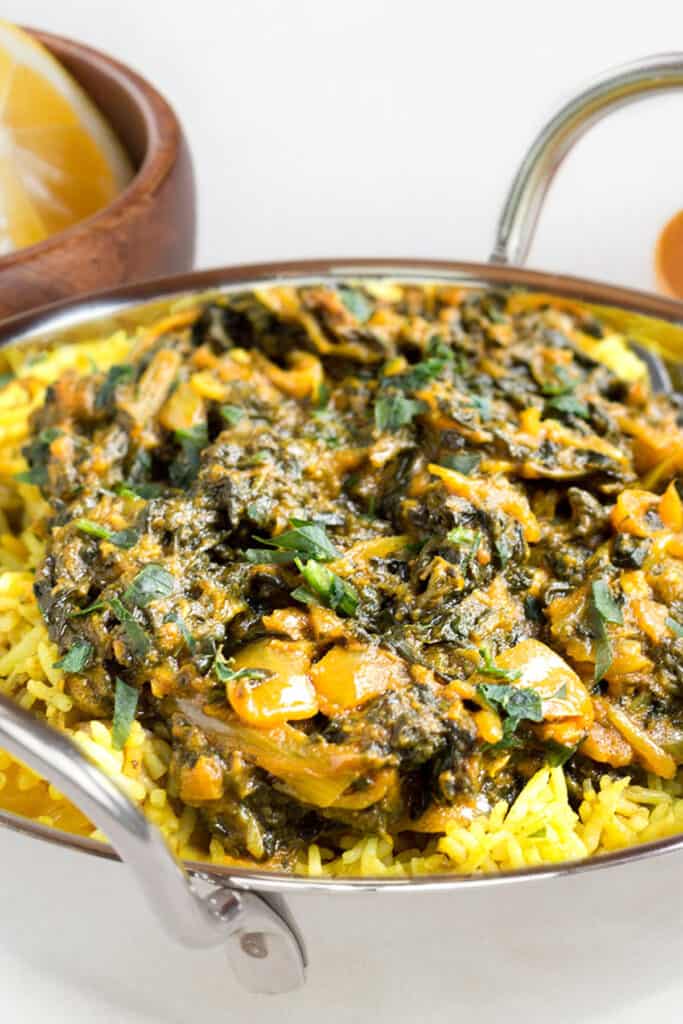 Sag Bahji {Spinach Curry} served over rice in bowl