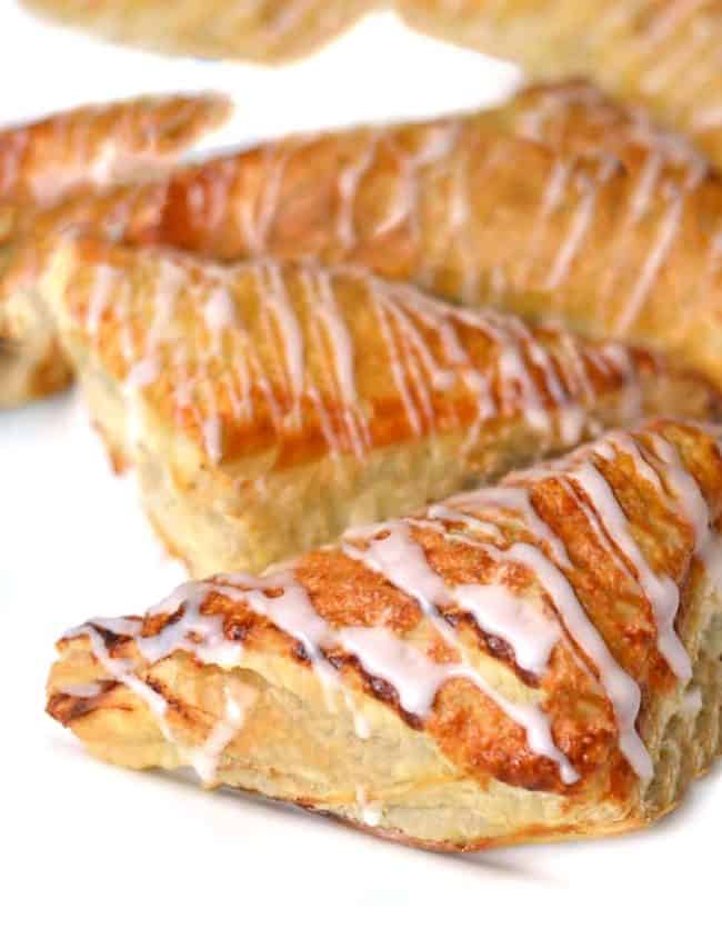apple turbovers drizzled with icing on a dish