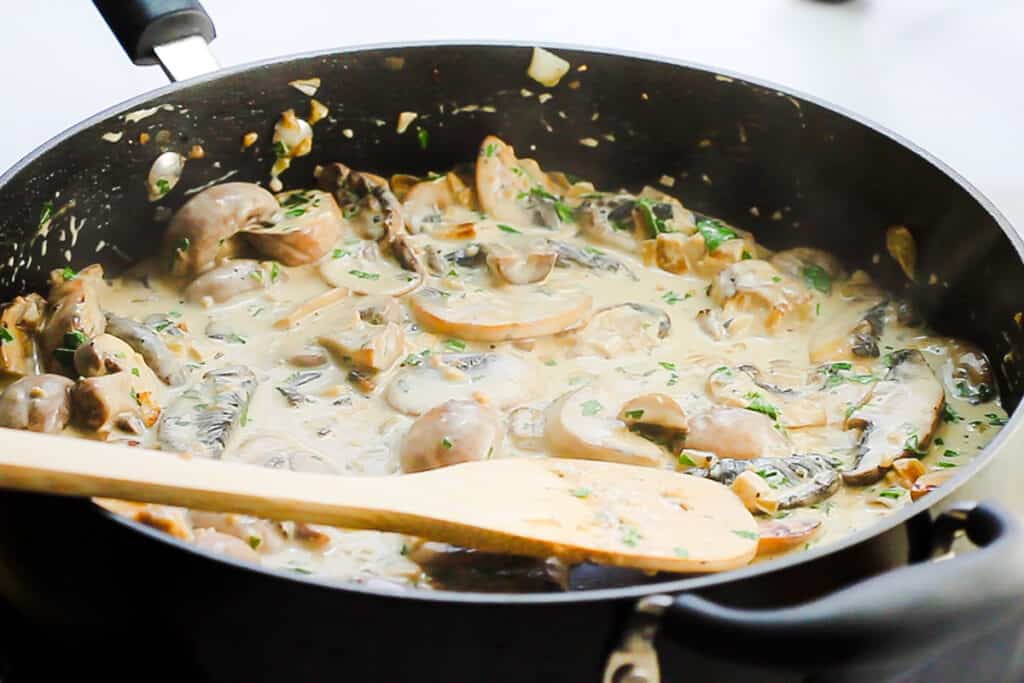 the finished creamy mushroom sauce in the pan.