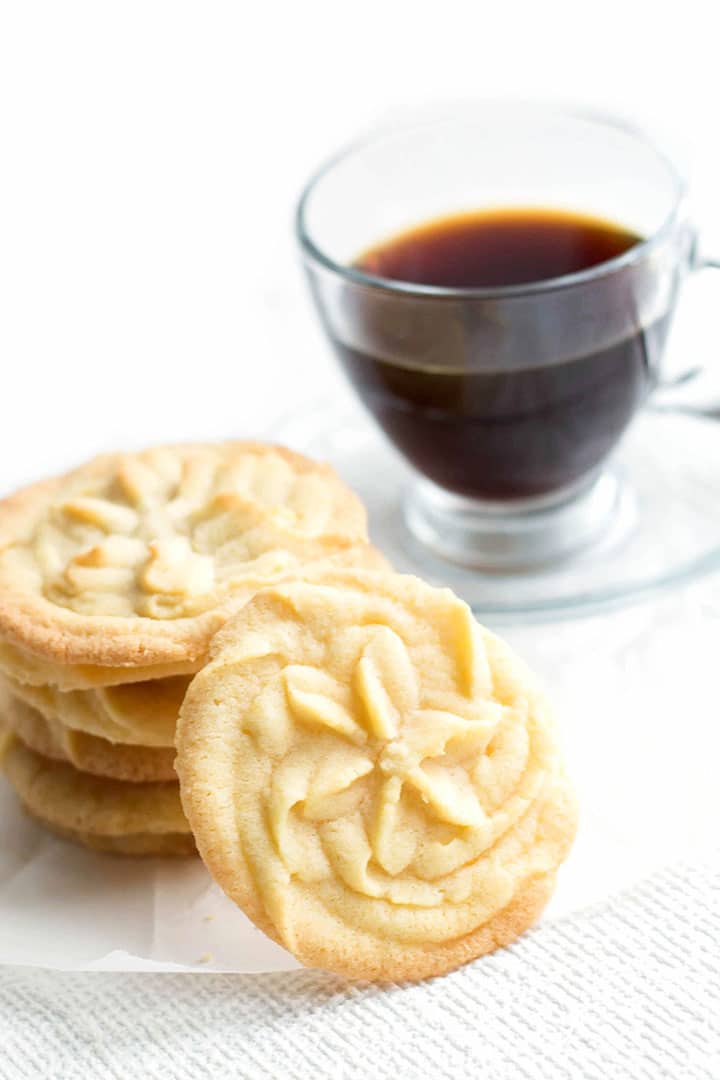 A close up of a plate of food and a cup of coffee, with Cookie and Butter