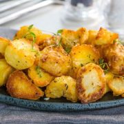 A dish piled high with golden, Crispy Roast Potatoes