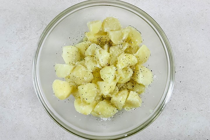 The potatoes on a sheet pan ready to bake