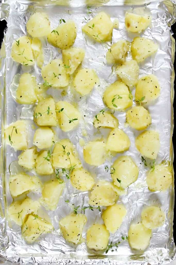 The potatoes on a sheet pan ready to bake