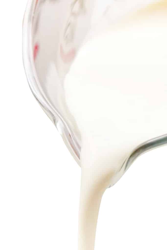 cream being poured from a jug