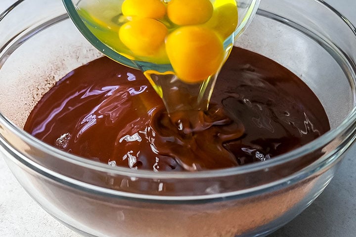 The eggs being added to the bowl