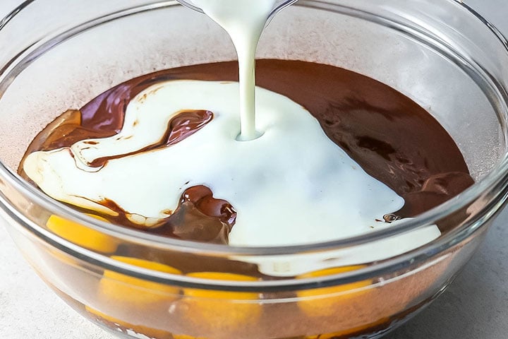 The buttermilk poring into the bowl