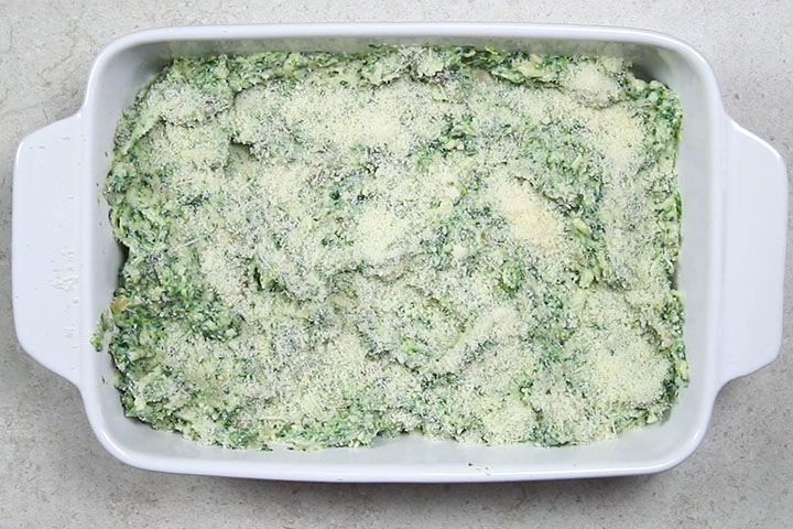 The dip sprinkled with Parmesan cheese ready for the oven 