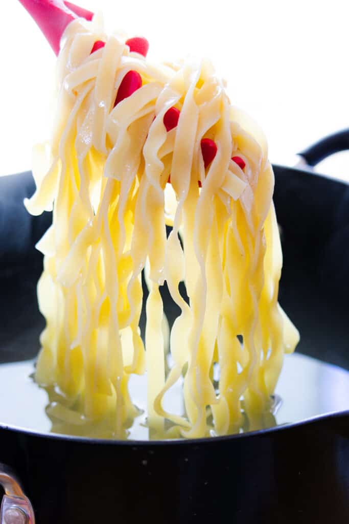 tagliatelle in a pan of boiled water