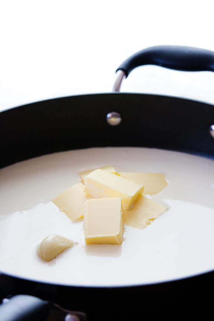 butter added to the cream with a clove of garlic