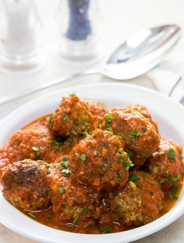 A dish full of Low Carb Italian Meatballs sprinkled with fresh parsley.