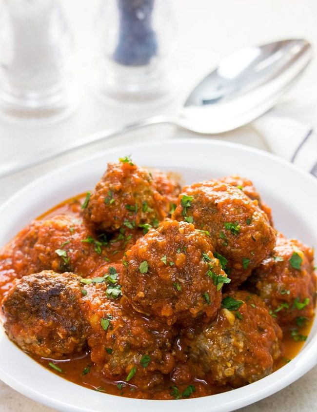 A dish full of Low Carb Italian Meatballs sprinkled with fresh parsley.