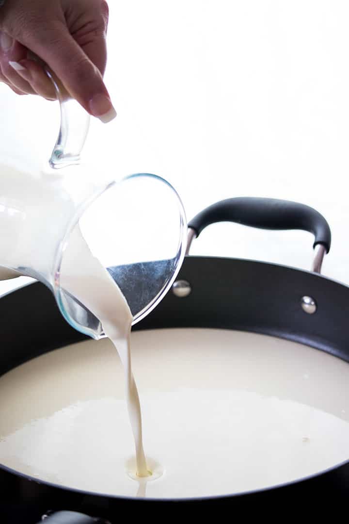 milk being poured into a pan