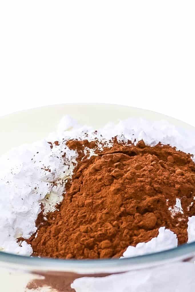 the ingredients for Chocolate Whipped Cream in a glass bowl