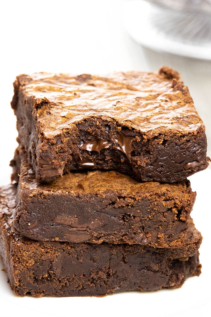 Easy Chocolate Brownies stacked 3 high with a bite taken from the top one