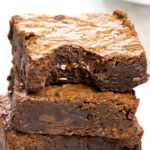 Easy Chocolate Brownies stacked 3 high with a bite taken from the top one